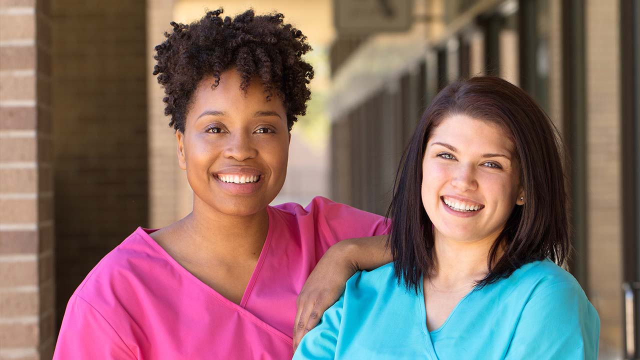 physicians out side the clinic in scrubs waiting for patients to arrive for consultations